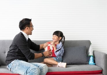 asian daughter give present for father. concept surprise gift box for fathers day.