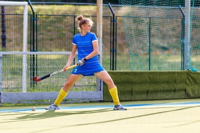field hockey player performing corner penalty shot.