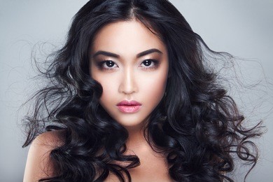 young and beautiful asian woman with curly hair