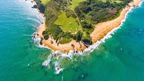 shanqin bay, wanning county, hainan island, china, a seaside golf course built on a rolling land that overlooks the south china sea. aerial view.