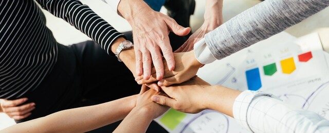 panoramic teamwork business join hand together concept, business team standing hands together, volunteer charity work. people joining for cooperation success business.