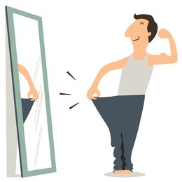 happy man standing in front of mirror and see himself slim and fitness.
