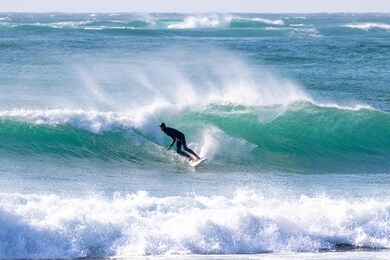 japan surfing , sometimes during a typhoon, there are many waves in japan especially in hebara, katsuura, chiba. westerner surfs large waves. sunrise & at the beach with a surfer & his surf board.