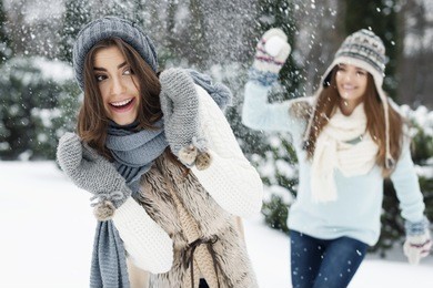 young women have fun during the snowball fight