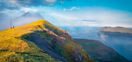 amazing morning view of popular tourist destination - sornfelli. wonderful summer scene of streymoy island. misty seascape of atlantic ocean, faroe islands, kingdom of denmark, europe.