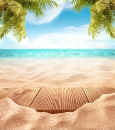 tropical fine sandy beach with blured sea sun sky clouds background with wooden table top and empty space for product advertisement montage of summer relaxation background