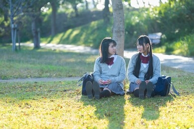 high school students studying in the park
