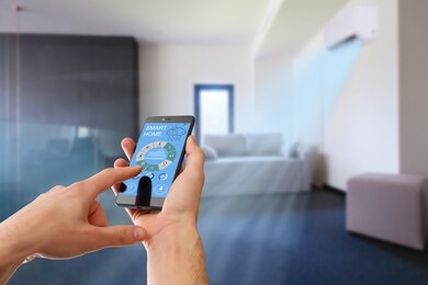 air conditioner remote control with smart home system on digital device.