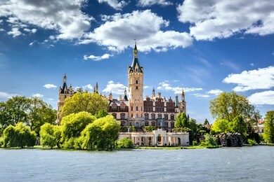 schwerin castle looking like a fairy tale castle surrounded by a wonderful landscape composed of lakes and forests 
