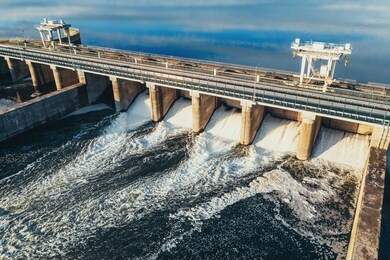hydroelectric dam or hydro power station at water reservoir, aerial view from drone. draining water through gate, hydropower.