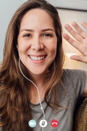 portrait of happy 30s aged beautiful girl making facetime video calling with smartphone at home. waving on phone screen. using conferencing meeting online app, social distancing, concept