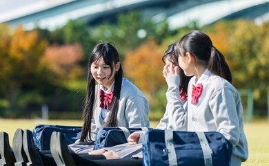 high school student sitting on the lawn
