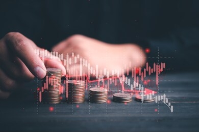 chart with red down arrow with businessman stacking rows of coins. falling growth in business. graph down world economic recession concept.