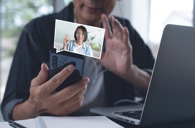asian business man talking to colleague in video conference. business team using zoom online meeting app via laptop computer in video call. group of people smart working from home, telework concept