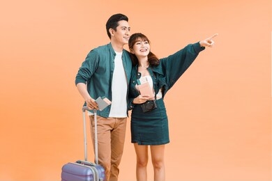 happy excited young couple tourists holding passports and boardingpasses ready for travel 