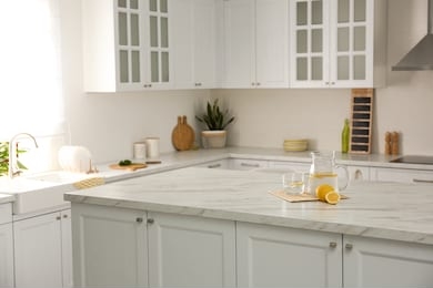 fresh lemonade on white marble table in kitchen. stylish interior design
