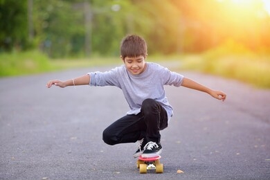 boy learn to skate on skateboard.child and skateboarding in park