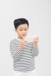 happiness asian kid playing on smart phone