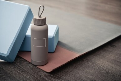 yoga mat, bottle with water and yoga bricks - accessories for home yoga practice
