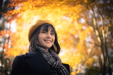 lifestyle portrait of pretty smiley young asian woman traveller in autumn season park, tokyo, japan, asia