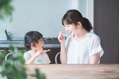 asian young mom and daughter brushing teeth in the room