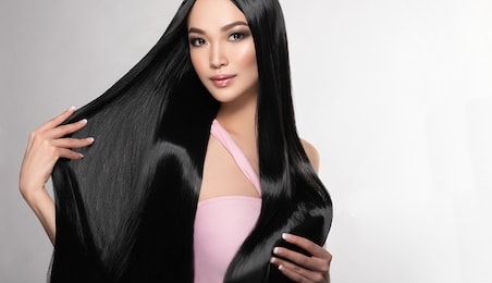 beautiful asian model girl with shiny black and straight long hair . keratin straightening . treatment, care and spa procedures for hair . chinese girl with smooth hairstyle