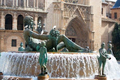 valencia plaza de la virgen square with neptuno fountain and cathedral at spain