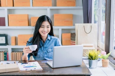 asian beautiful woman having coffee break relax happy relief working from home office in isolation quarantine, smiling working on desk using computer laptop typing planning strategy business company