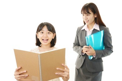 teacher with teen girl studying.