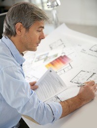 architect working on construction project in office
