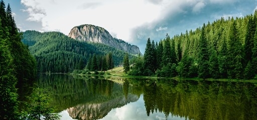 summer scenery of mountain lake lacul rosu (red lake or killer lake). popular travel destination and place for active rest and adventures in eastern carpathians. harghita county, romania