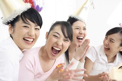 group of japanese females laughing at a party