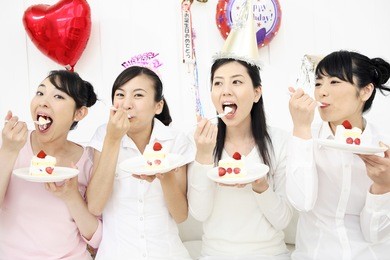 group of japanese females eating cake at a party
