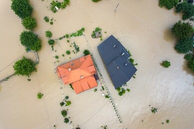 aerial view of flooded houses with dirty water of dnister river in halych town, western ukraine.