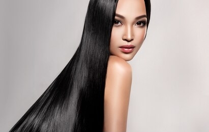 beautiful asian model girl with shiny black and straight long hair . keratin straightening . treatment, care and spa procedures for hair . chinese girl with smooth hairstyle