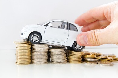 car with helping hand on coins