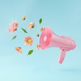 pink megaphone with colorful summer flowers and green leaves against pastel blue background. advertisement idea. minimal nature concept.