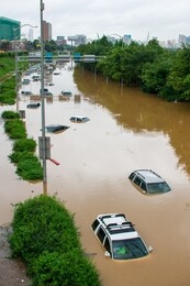 flooded car on the road after downpour