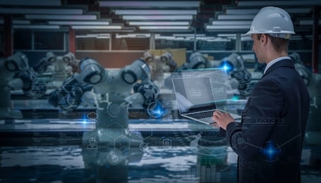 industry 4.0 robot concept .engineers use laptop computers for machine maintenance, automation tools, robot arm at the factory.