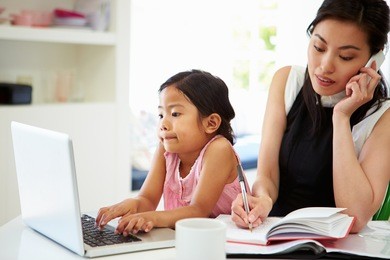 busy mother working from home with daughter