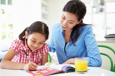 mother helping daughter with homework