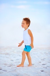 cute boy walking the salted lake firth