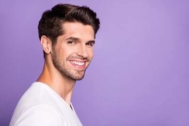 close-up profile side view portrait of his he nice attractive content brown-haired cheerful cheery guy modern look isolated over bright vivid shine vibrant lilac violet purple color background