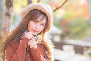 
a young woman reflected in the background of autumn leaves