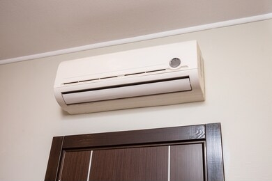 white under the ceiling on the wall above the door to the room