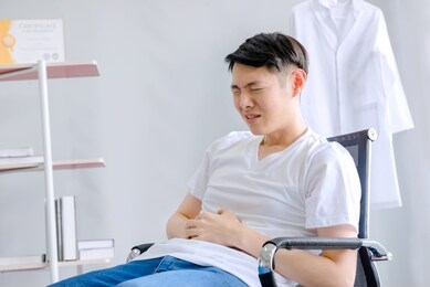 male doctor has severe stomach pain in the office hospital office