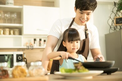 daddy and his little daughter cooking in the kitchen