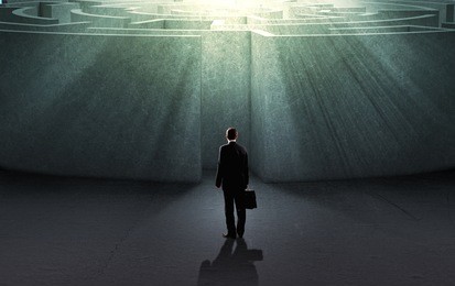 successful businessman standing near the entrance of labyrinth