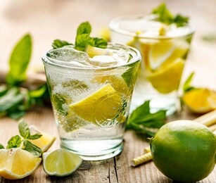 refreshing summer drink with lemons, limes and fresh mint close up view