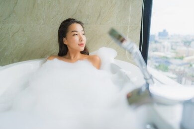 portrait beautiful young asian woman relax and leisure in bathtub decoration in bathroom interior